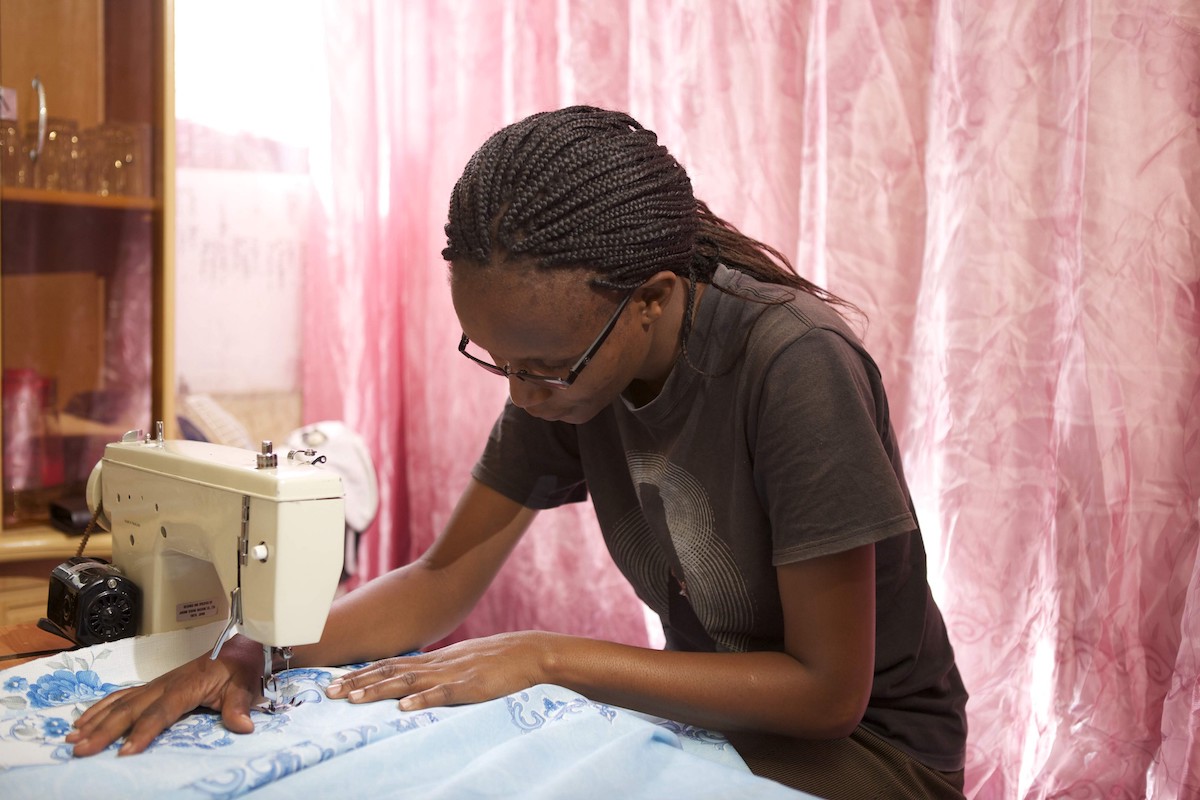 Tailor using sewing machine